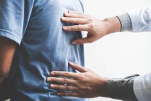 Doctor checking patient with spine to determine the cause of ill